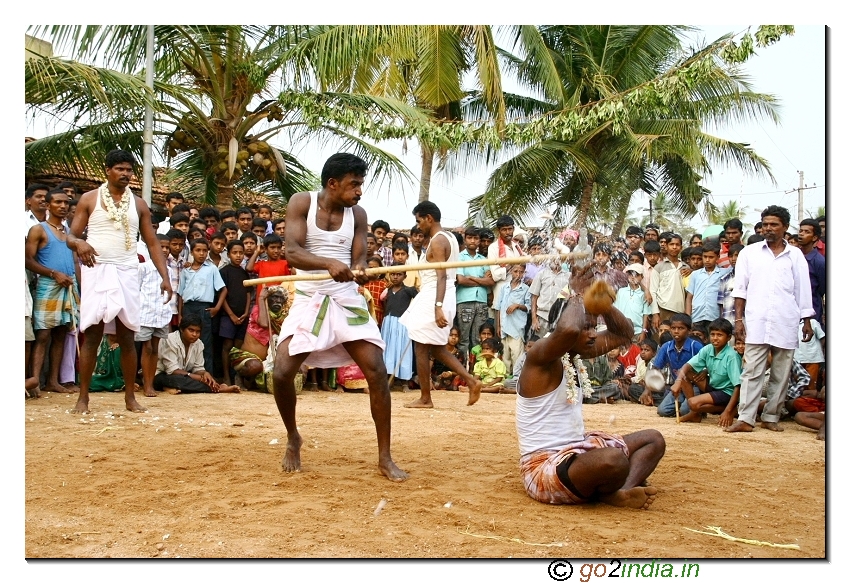 Breaking the coconut with stick during the festival