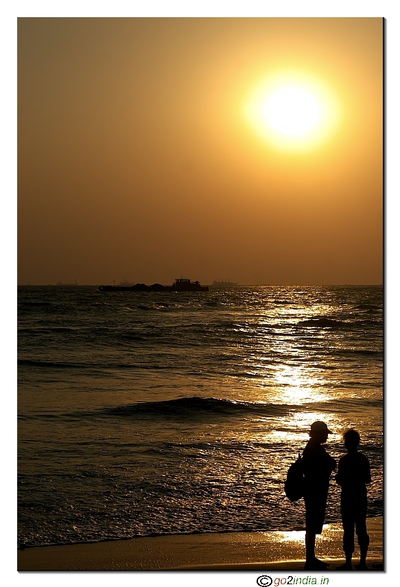 Couple see sunset view at Goa Meera palem beach