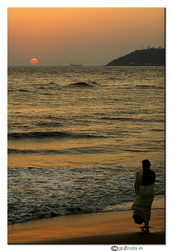 Lady viewing the sun set at Meera palem beach in Goa near Panaji