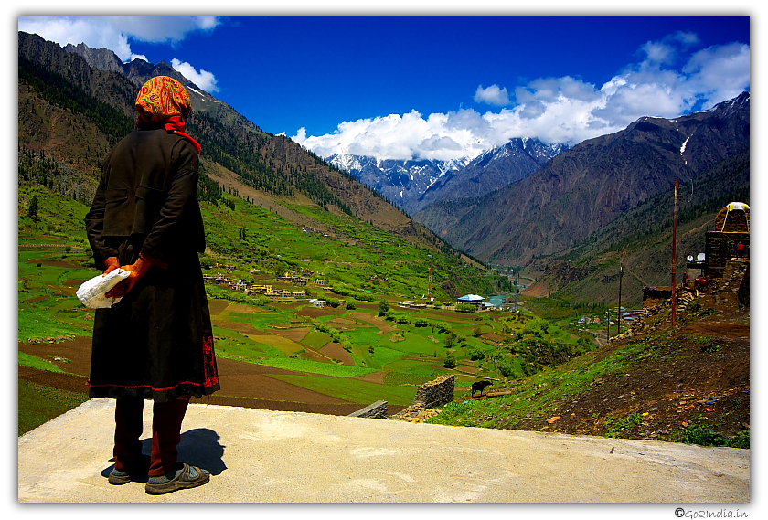 Woman looking at Himalayan valley view from Trilokinath temple