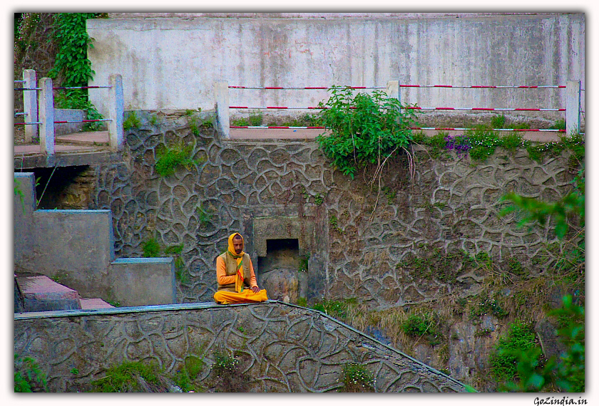 A sage meditating on the river side.