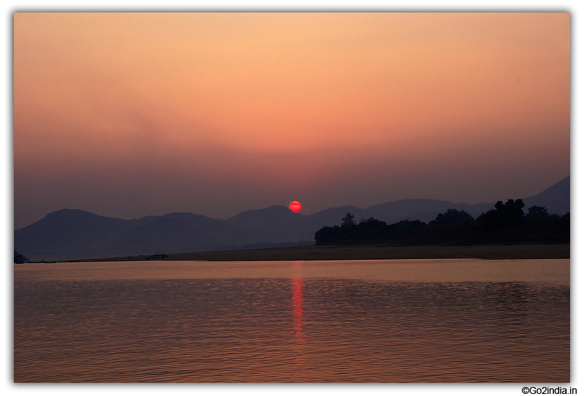 Red sun just before sunset on river Godavari
