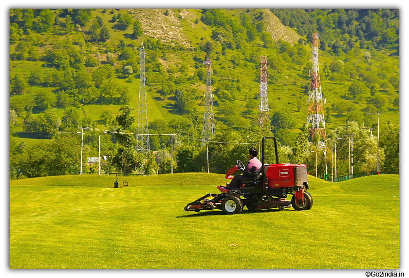 Cutting the grass at golf ground at Pahalgam