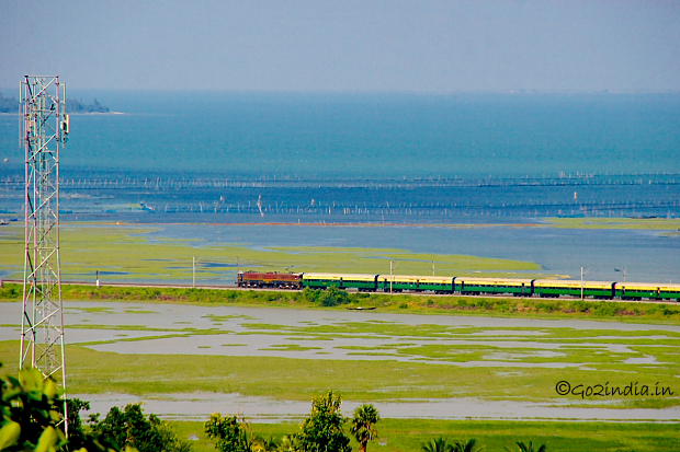 Train passing by side of Chilika Lake