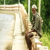 Old village man sitting over a bridge in rural Andhrapradesh of India