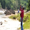 Person taking video near a river