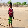 Photo of a boy looking curiously near a beach