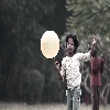 girl holding balloon playing desaturated colours