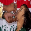 Giving polio drops to children in India
