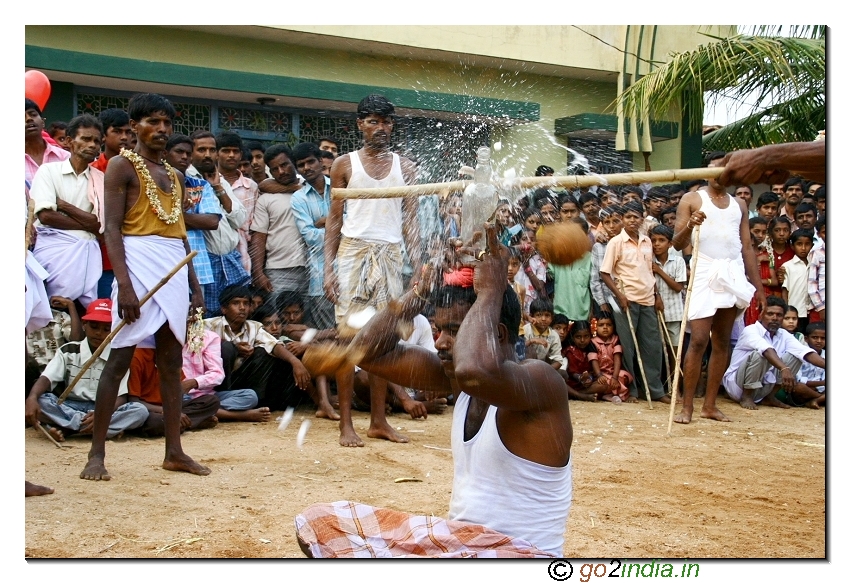 Breaking the coconut with stick during the festival