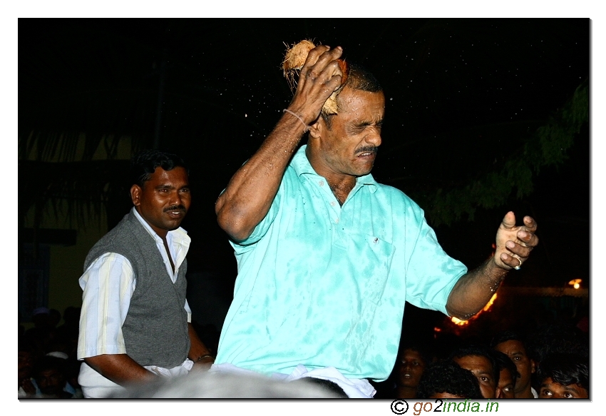 Breaking the coconut with the head during the festival