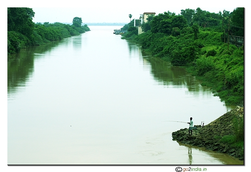 Man fishing at Dowlaiswaram barrage at river Godavari near Rajahmundry