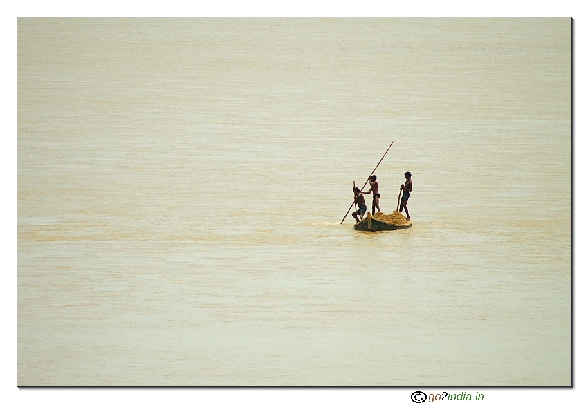 Children collecting sand from river Godavari to sell