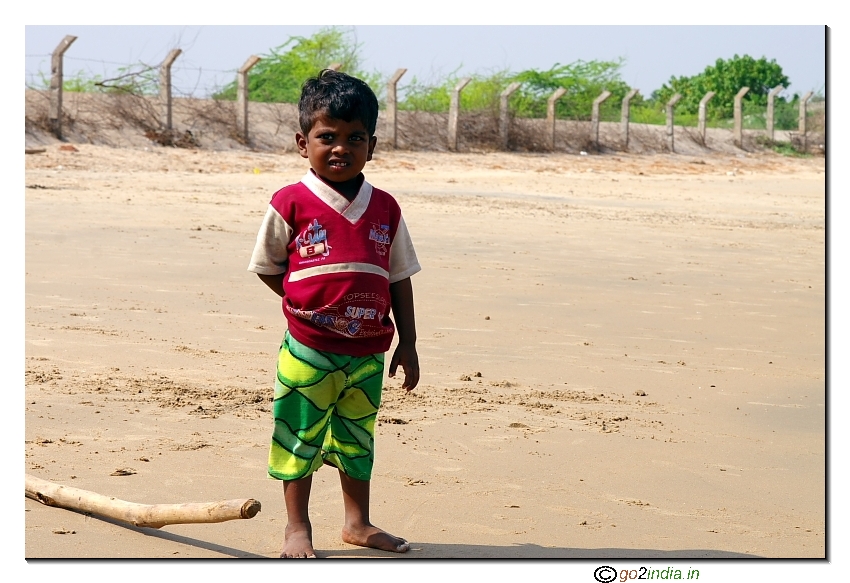 Photo of a boy looking curiously near a beach