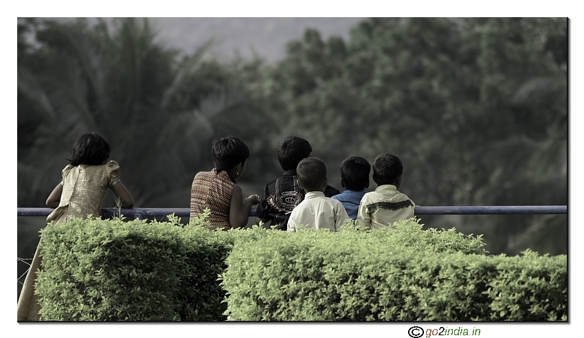 durious kids watching a lake, candid moment