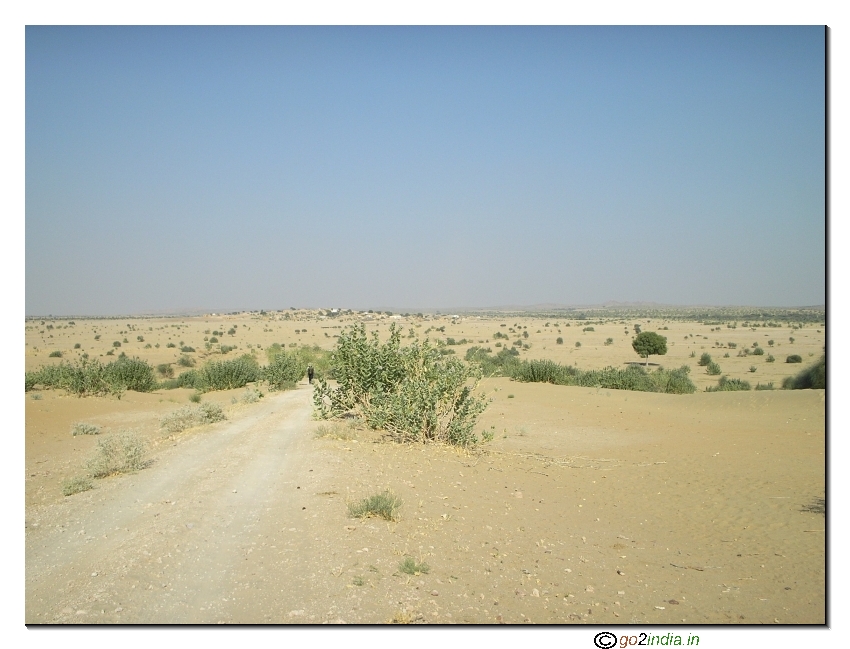 Trekking down a hill on sand desert 