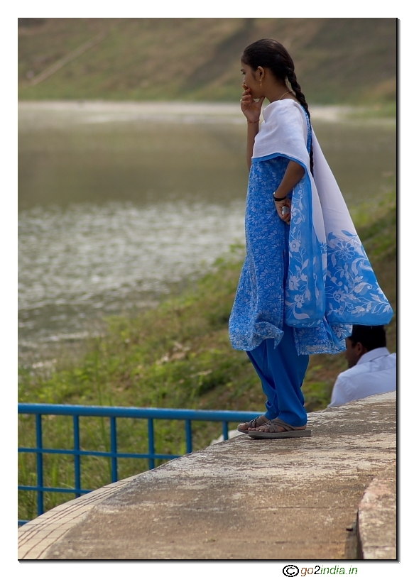 Girl looking at a pond curiously