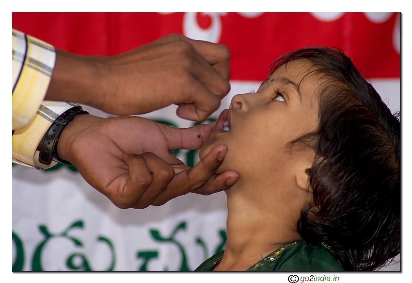 Giving polio drops to children in India