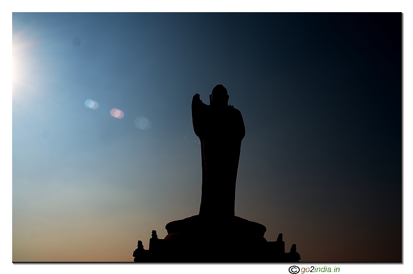 Buddha statue & sun at background