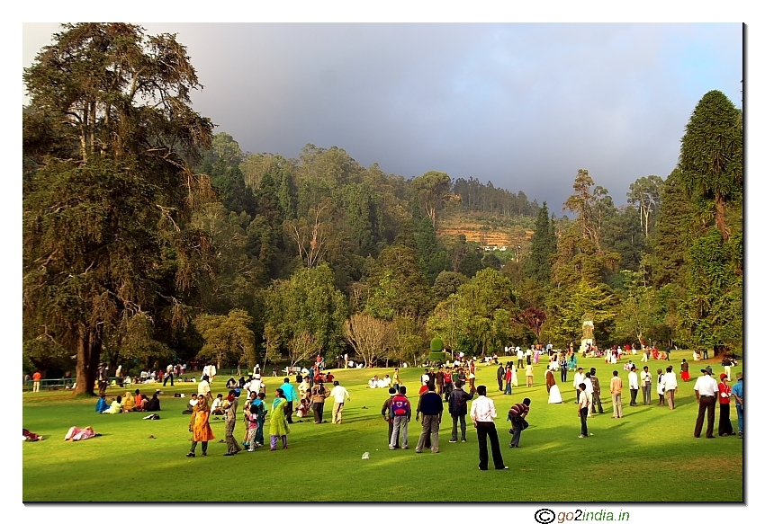 People having fun time in Botanical garden at the green lawn Ooty