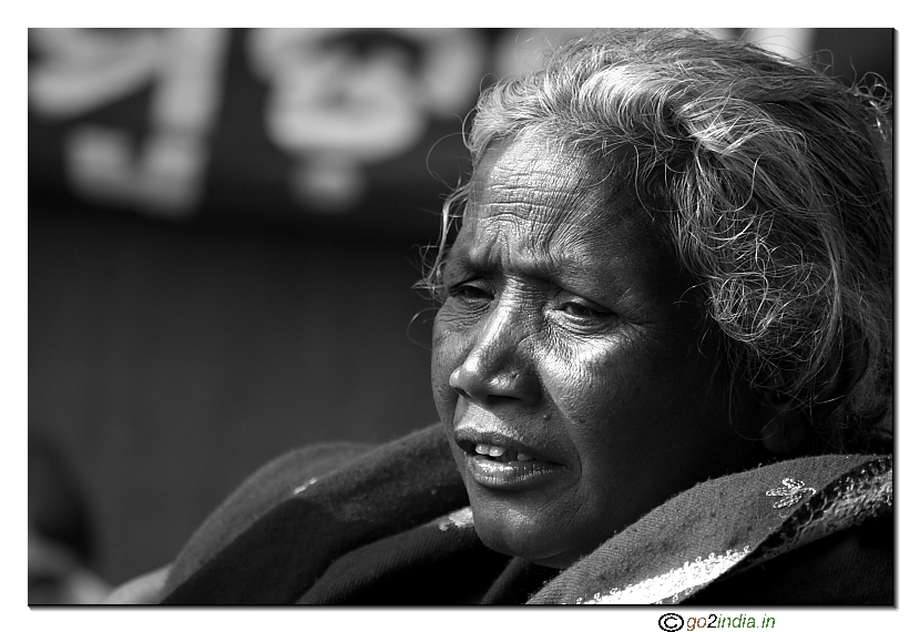 Old tribal lady looking at the crowd shot at Adivasi padaga Orissa