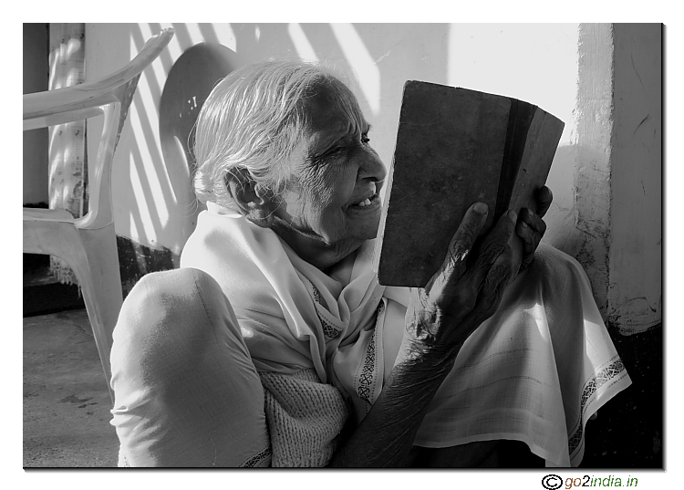 Old aged woman reading a book
