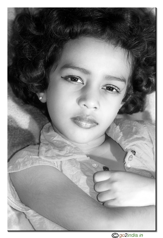 of a little girl sleeping to give pose for a photo shoot