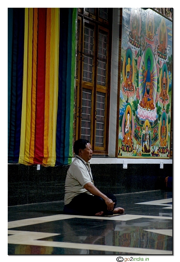 A person meditating inside a buddhist monestary