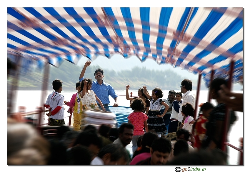 Group of people and kids dancing on a boat in river Godavari