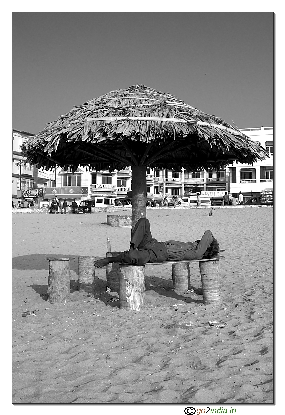 Man sleeping at beach at Puri