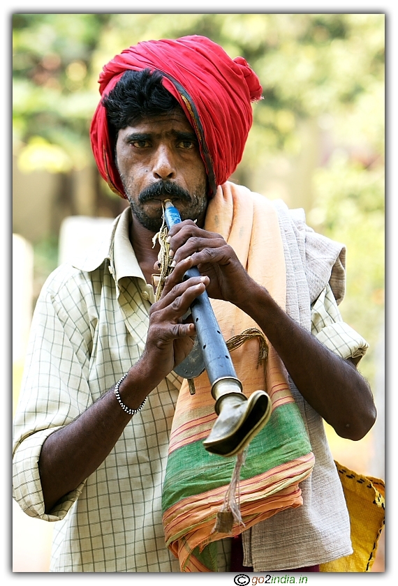 a village person playing the pipe