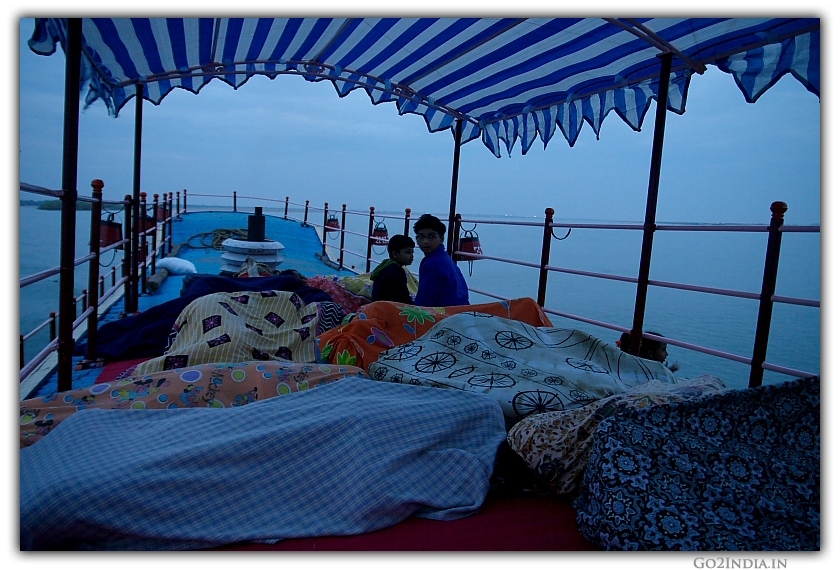 People sleeping at the deck of launch journey on Godavari river early morning