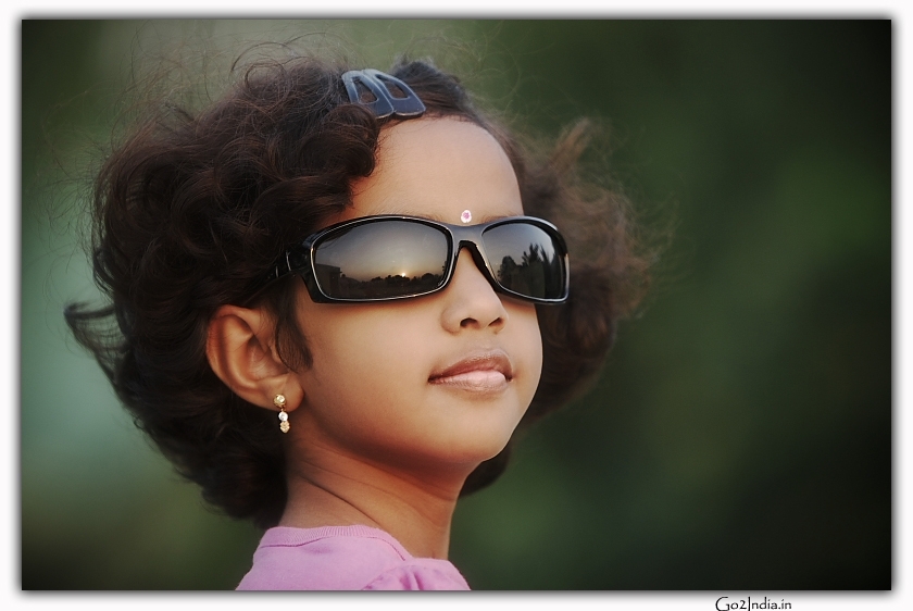 of a girl wearing black cooling glass posing for portrait