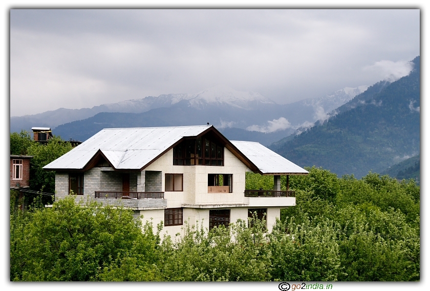landascape with house and coulds on snow peaks, Manali, kakhnal