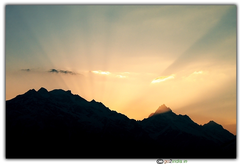 Sun rays gushing out from peaks