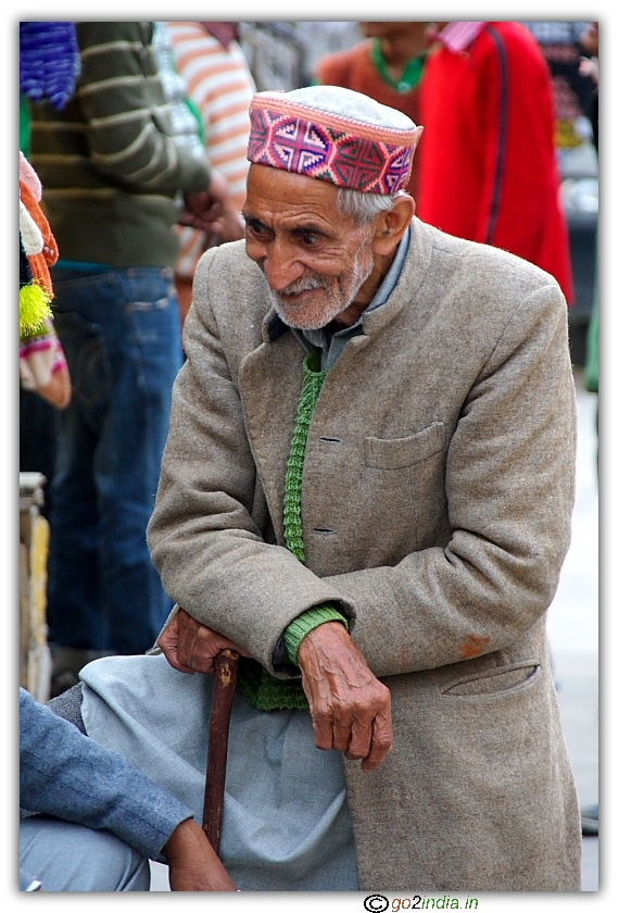 old man looking curiously at a conversation, streets of Manali
