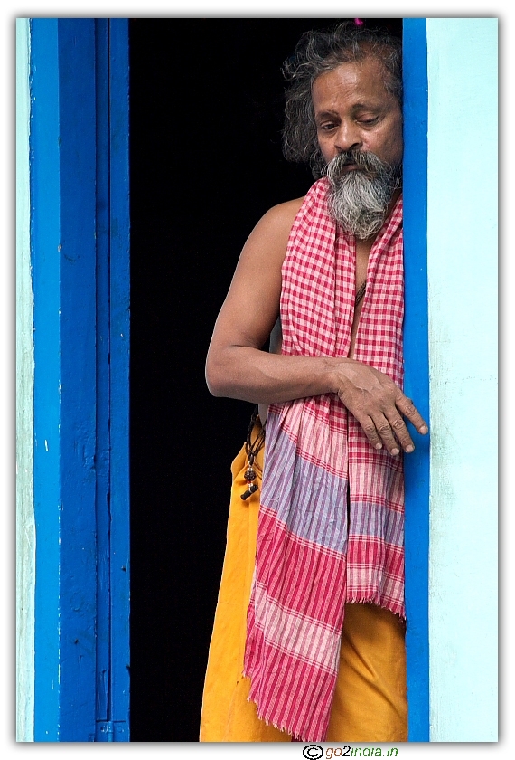 man looking interestingly at visitors at Shiva temple Manikaran