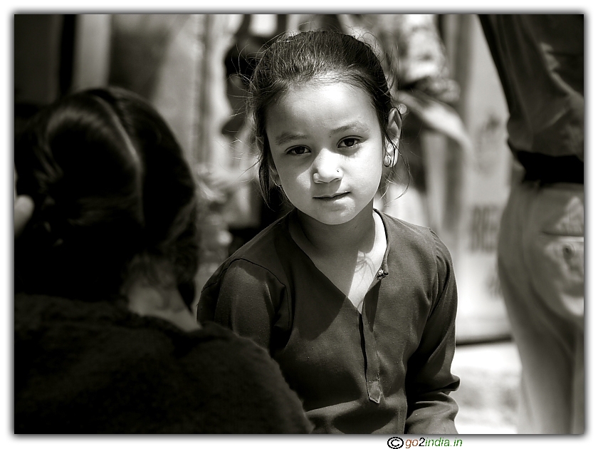 Girl looking at the photographer with a strange look