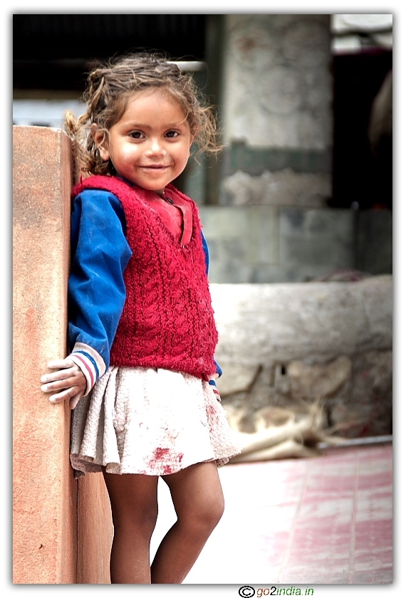 Poor Kid with a nice smile posing for photograph