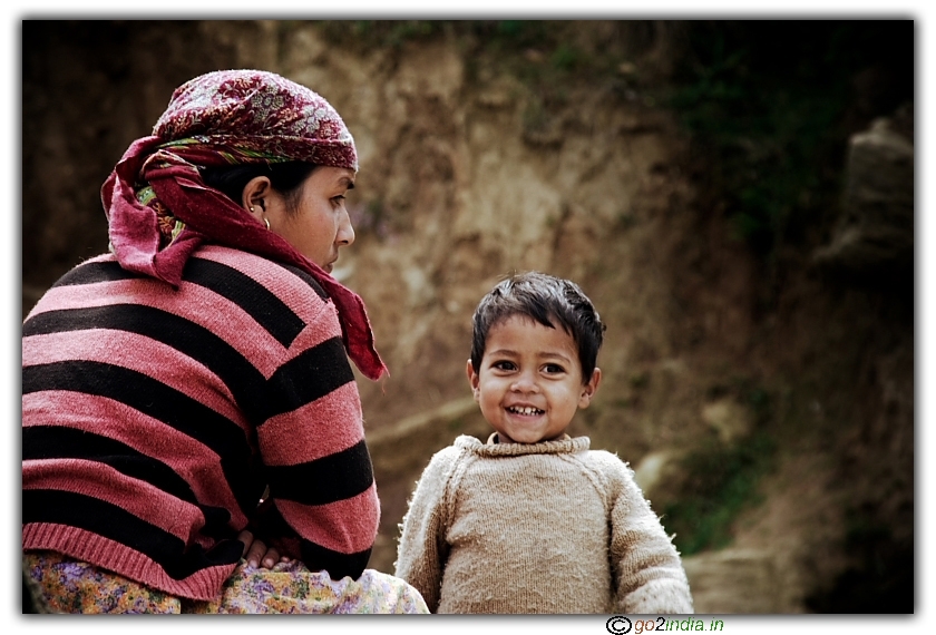 Boy along with mother looking smilingly