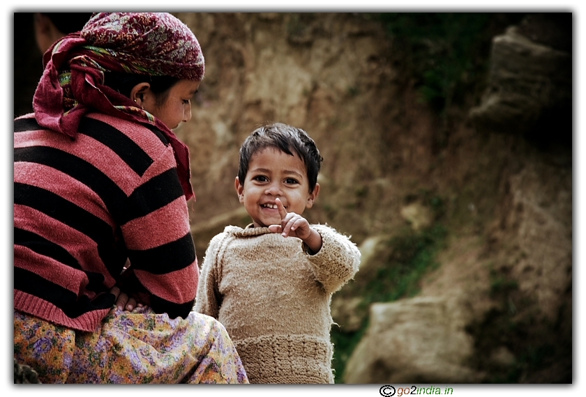 Kid pointing his finger at photographer