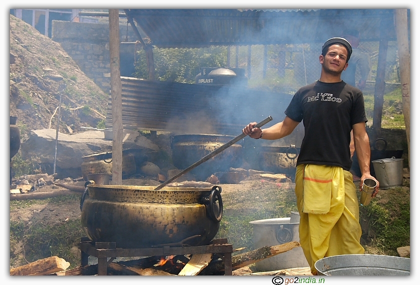person preparing food in an open ground near a temple