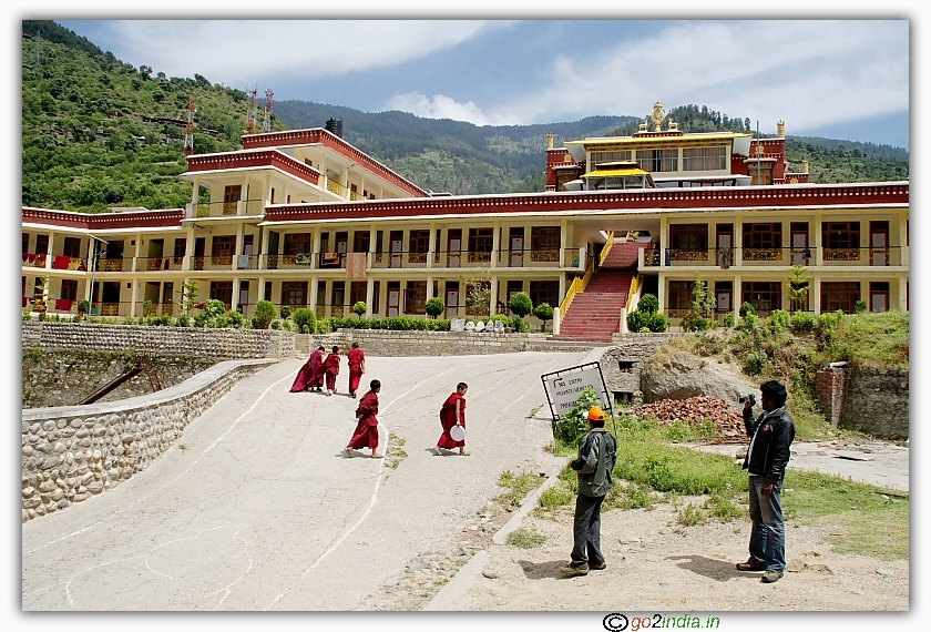 Tourists taking photo of buddhist monks and monastery