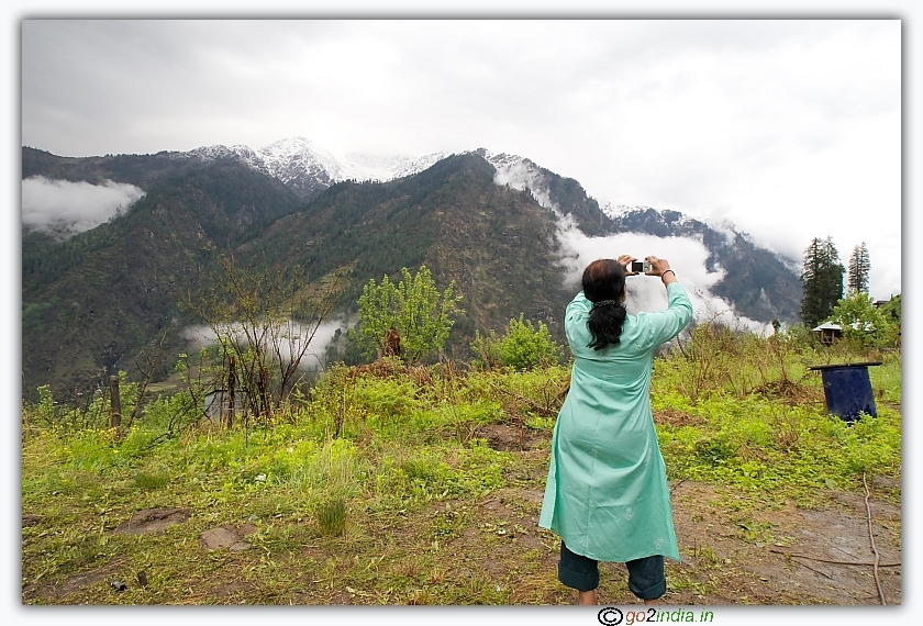 A trekker taking photo of Himalaya at Guna pani