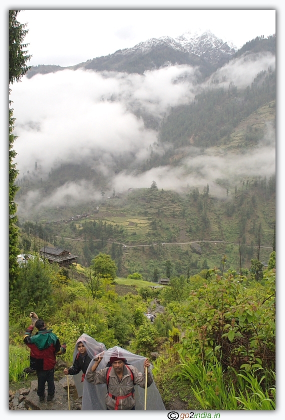 Himalayan trekkers with plastic covers during rain