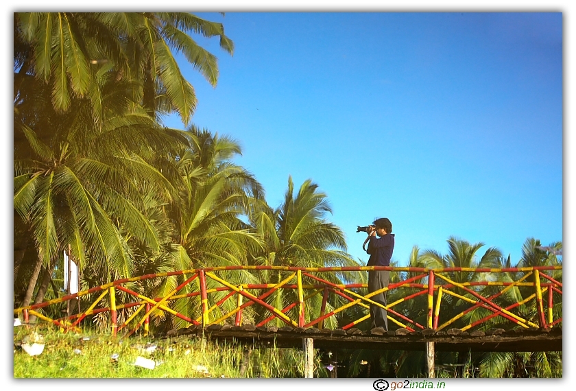Photographer on a wooden bridge at Yarada beach
