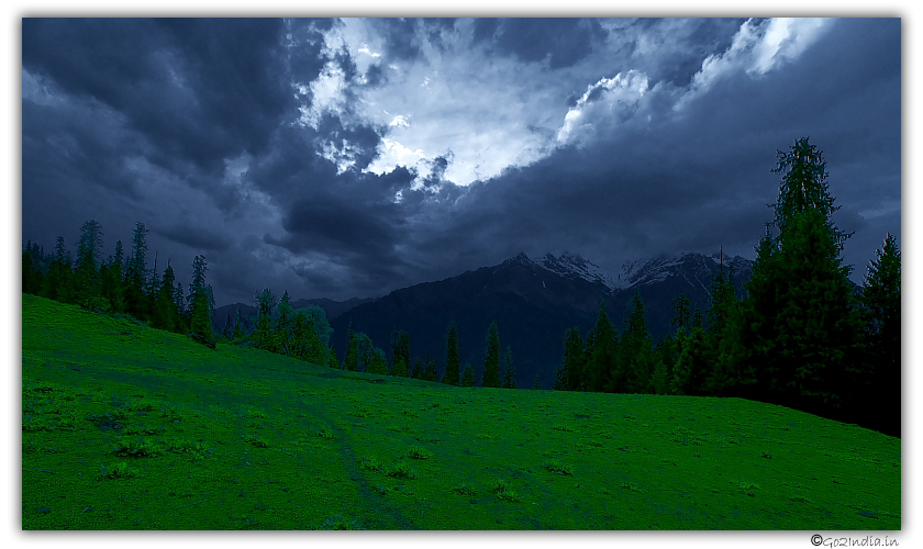 Green land and dark clouds at Bhandak Thatch