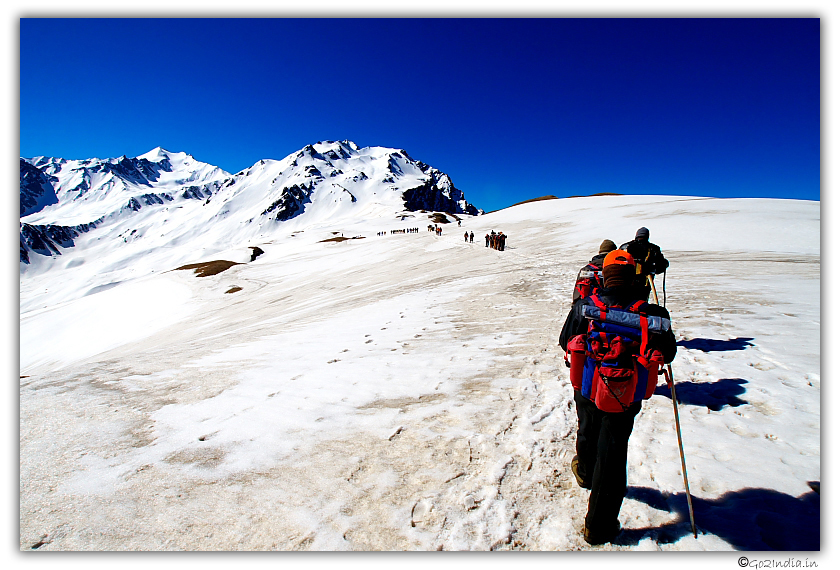 Trekkers Walking on Ice in Himalaya Sarpass trekking