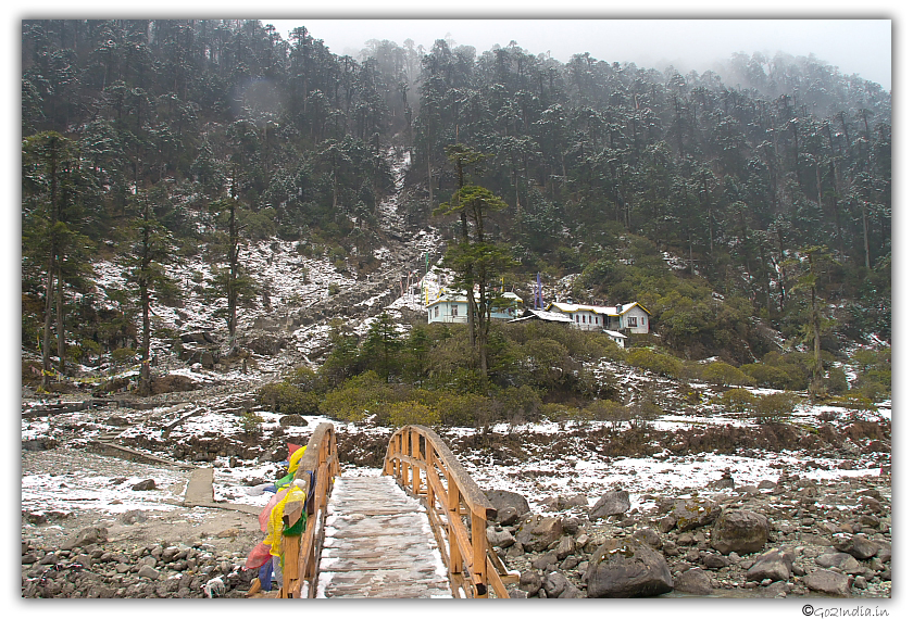 Small bridge over river Lachung covered with ice