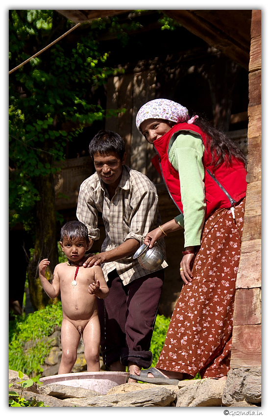 Parents bathing their kid